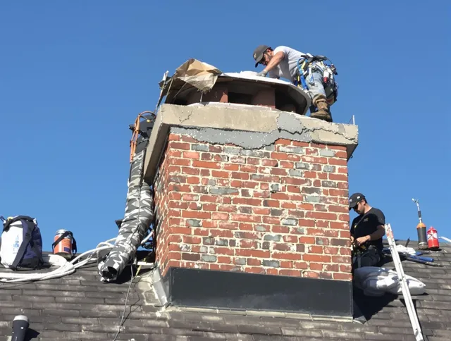 Mayfield Heights Chimney Sweep installing a custom chimney crown in Mayfield Heights, OH